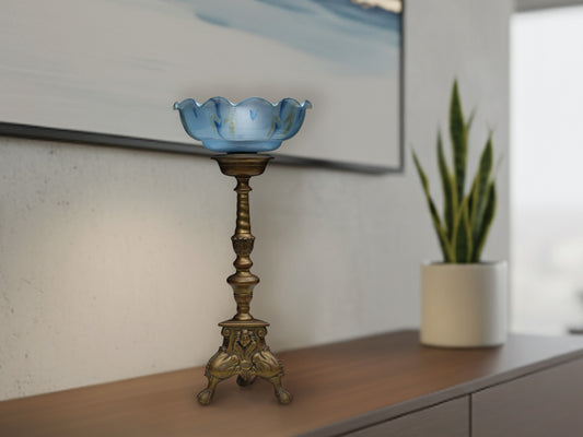 A vintage Pillar candle holder converted to a unique table lamp . This solid brass candle holder is one of a set we found in Brugge Belgium estimated early to mid-20th century. The blue shade is glass or opaline and dates from around the same time period.