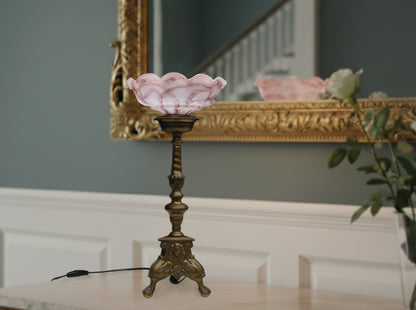 Vintage solid brass candle holder converted to an elegant vintage table lamp . The solid brass pillar candle holder is one of a set we found in Brugge Belgium estimated early to mid-20th century. The pink shade is glass or opaline and dates from around the same time period.  