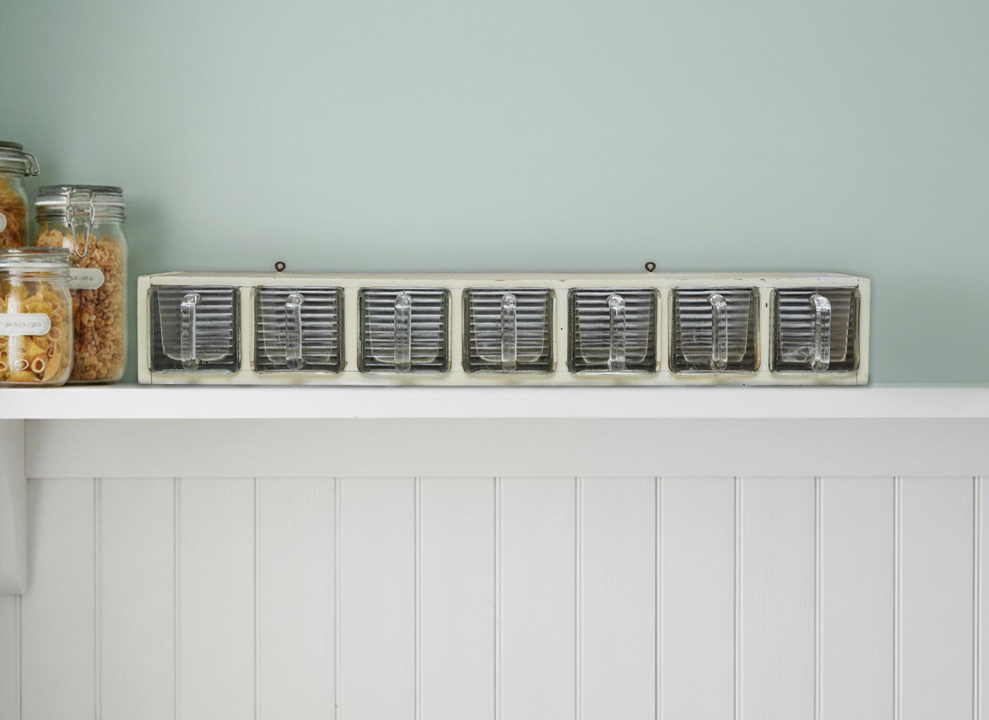 Rare 1930s German Vintage Weck wall spice rack. Solid wood shelf with original patina and seven heavy glass drawers. Perfect functional retro spice rack for vintage kitchen and modern/vintage home decor.